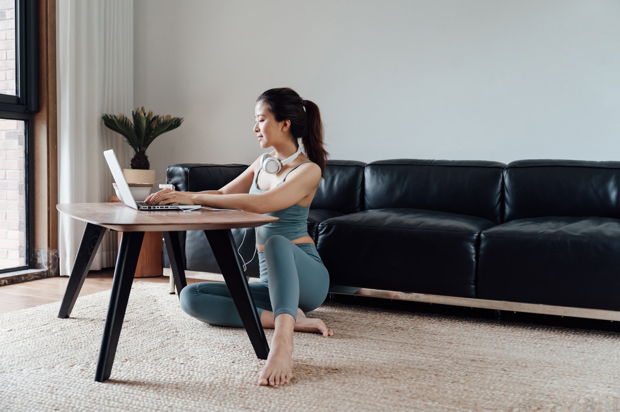 young-asian-woman-working-on-a-laptop-ZJTBGY6